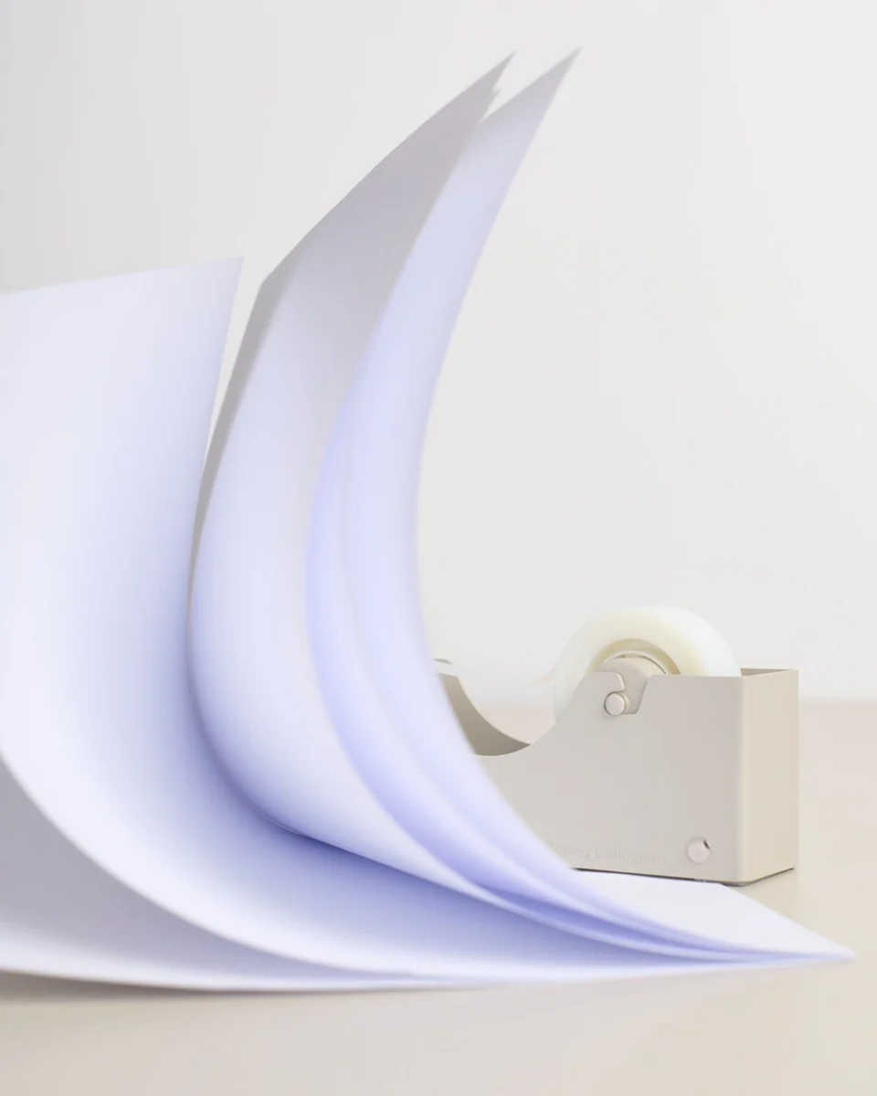 The Boring Tape Dispenser with paper flying over it